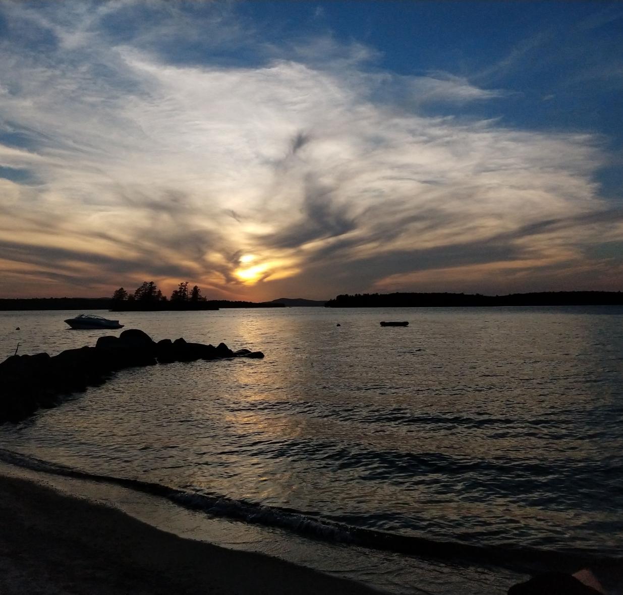 Cloud formation over water at dusk